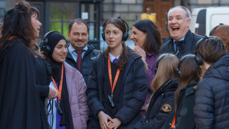 Minister for Business, Richard Lochhead, laughing with students from Holy Rood High School during 'A Day in Edinburgh' ghost tour of Edinburgh.